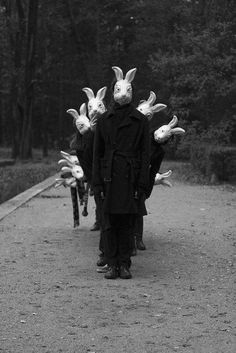 a person wearing bunny ears walking down a road