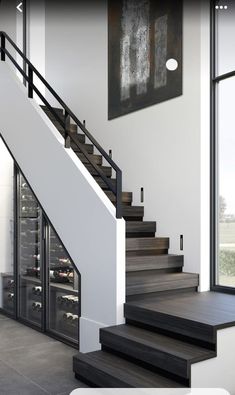 there is a wine cellar in the middle of this room and stairs leading up to it