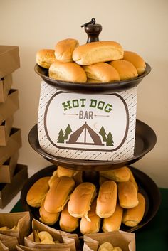 hot dogs and buns stacked on top of each other at a camping birthday party