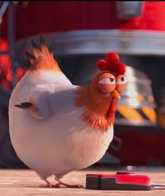 the angry bird is standing in front of a firetruck and looking at something