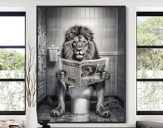 a lion sitting on top of a toilet reading a newspaper with his paws in the air