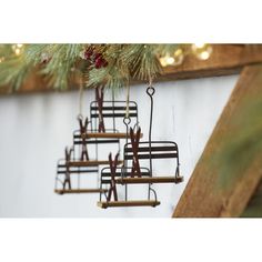 a christmas ornament hanging from a pine tree with scissors in the shape of bells