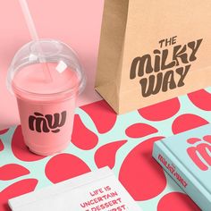 the milkshake is next to an open book and a paper bag that says, the milky way