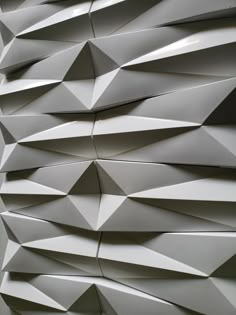 an abstract wall made up of white paper