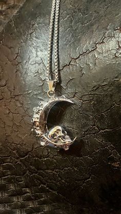 Pictures do not capture the beautiful of the shiny silver color that this pendant has. This stainless-steel Cresent Moon Skull Necklace is very detailed with large and small craters that add to the character. The Crescent moon measures 2.8 inches tall by 2-5 inches wide and the chain is 22 inches.   The stainless-steel double skull necklace measures 2.5 inches tall by 1.7 inches wide and the chain is 22 inches.   The coffin pendant is 1.8 inches tall with a 22-inch chain.  The spartan flag helmet pendant is 1.4 inches tall, and the chain is 20 inches.  All shipping is free and mailed within 1 business day from Scottsdale, Az. Moon Skull, Crescent Moon Jewelry, Edgy Jewelry, Jewelry Gothic, Gothic Skull, Skull Jewelry, Skull Necklace, Moon Jewelry, Scottsdale Az