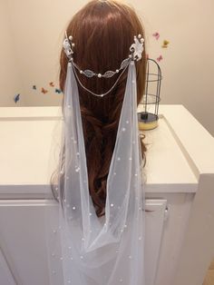 the back of a woman's head wearing a veil