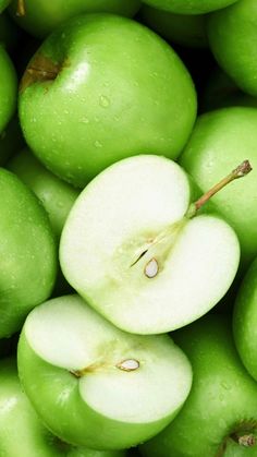 a pile of green apples sitting next to each other