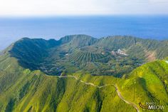 an aerial view of the mountains and valleys in the tropical country side, with roads winding through them