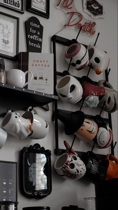 there are many coffee cups and mugs on the wall