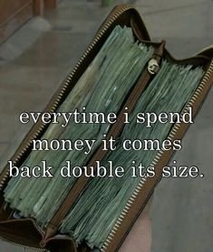 someone holding a wallet full of money with the words, every time i spend money it comes back double its size