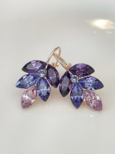 Gorgeous pair of leaf earrings featuring Swarovski 8x4mm marquise crystals shades of cool purples.  So pretty!  Shown in the rose gold metal finish. Earrings are 1 inch long as shown, 3/4 inch long in the post-back version.  Please select style from the drop down menu at checkout. Thanks for stopping by! Violet Gown, Mauve Earrings, Shades Of Cool, Jewellery Luxury, Types Of Gems, Purple Earrings, Earrings Bridesmaid, Purple Ombre, Classy Jewelry