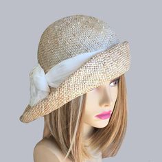 This couture hat was handmade on an antique hat block using a natural knotted parasisal straw. This lovely hat is embellished with a Ivory silk dupioni fabric. Please indicate your head size measurement when ordering (measure your head horizontally just above your eyebrows). When you receive your hat, there will be a small ribbon inside to fine-tune the fit, and a hat box for safe storage. Note: Colors will vary depending on your monitor and there will also be some variations due to dye lots. I personally create each hat one at a time, and no two are ever exactly the same.  My hats are 100% handmade for you, using traditional Millinery techniques and the highest quality fabrics and details.  I frequently trim  my hats with one-of-a-kind details, i.e. vintage buttons, antique brooches, ribb Straw Cloche Hat, Antique Hat, Cloche Hats, Couture Hats, Silk Dupioni, Hat Blocks, Antique Hats, Hat Summer, Millinery Hats