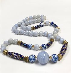 "Vintage Blue Lace Agate Stone Beads, Vintage Chinese Cobalt Blue Cloisonne Focal Beads, Vintage Hand Painted Chinese DOUBLE HAPPINESS White Cobalt Blue Porcelain Beads, Vintage Chinese Porcelain Hand Painted White Cobalt Blue LADYBUG Beads If a whisper were a color, I've always thought it would be the color of blue lace agate - a soft shade of blue unlike any other. A focal 20mm blue lace agate bead ( there are 25mm to the inch) is set off by 2 Chinese porcelain beads with the 'double happiness Cheap Vintage Blue Necklaces, Blue Ladybug, Lace Agate Stone, Chinese Embroidered, Blue White Porcelain, Porcelain Beads, Hand Knotted Necklace, Knotted Necklace, Asian Jewelry