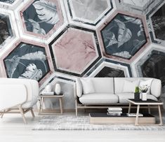 a living room filled with white furniture and walls covered in hexagonal wallpaper