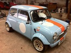 an old blue car with orange and white stripes