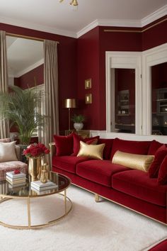 a living room with red couches and gold accents