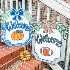 two welcome signs are sitting on the steps