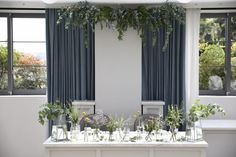 the table is covered with flowers and greenery