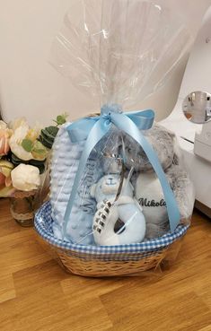 a basket filled with baby items sitting on top of a wooden floor