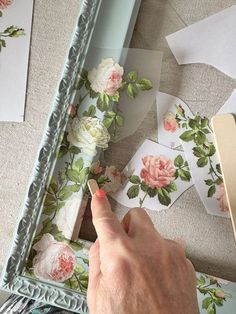 a person is using a pencil to draw roses on paper with flowers in the background