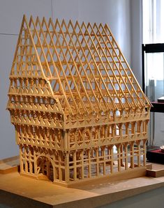 a wooden model of a house on display