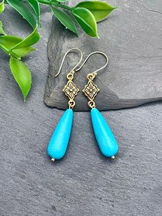 These elegant boho-style earrings showcase stunning, smooth Turquoise Howlite teardrops suspended from southwestern-inspired diamond-shaped connectors, reminiscent of floral and star patterns. They make an ideal selection for an effortlessly chic accessory. EARRING FEATURES Total Length: Approximately 2.75 inches Material: Turquoise Howlite Teardrops, Gold Tone ♥ All orders come beautifully hand-packaged with care, making it the perfect gift for yourself or someone special. ♥ Each piece is handmade with love in my home studio in Rockaway, NJ. Turquoise Drop Bohemian Jewelry, Bohemian Turquoise Drop Jewelry, Turquoise Bohemian Drop Jewelry, Bohemian Turquoise Teardrop Earrings For Jewelry Making, Bohemian Teardrop Earrings With Natural Stones, Bohemian Turquoise Teardrop Earrings, Bohemian Hypoallergenic Drop Earrings, Bohemian Turquoise Teardrop Drop Earrings, Bohemian Hypoallergenic Dangle Teardrop Earrings