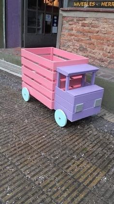 a purple and pink cart sitting on top of a sidewalk