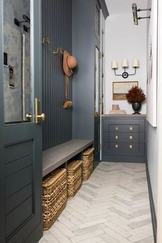 a hallway with gray walls and baskets on the floor