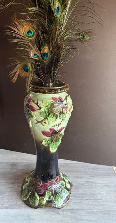 there is a vase with peacock feathers in it