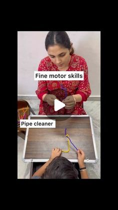 two girls are working on a project with pipe cleaner and paper cutters in front of them