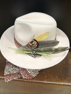 A pink western hat with matching scarf. The hat is made of felt and accessorized with feathers. The hat can be adjusted with the ribbons ties inside the hat for your comfort. Don't delay order yours today. Pink Fedora, African Hat, African Hats, Chapeau Cowboy, Western Hat, Western Hats, Cow Boy, Zulu, Ribbon Tie