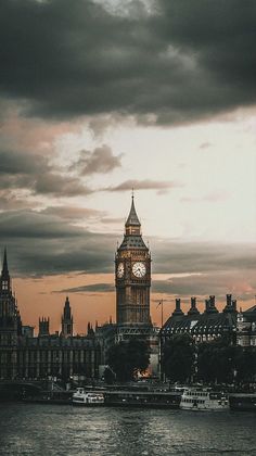 the big ben clock tower towering over the city of london, england at sunset or dawn