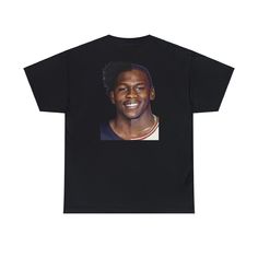 a black t - shirt with an image of a man's face on it