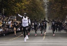 a group of people that are running in the street