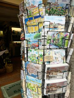 a book stand that has many books on it and is holding several different types of cards