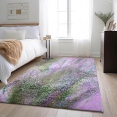 a bed room with a neatly made bed and a purple rug on the hardwood floor