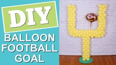 the balloon football goal is made out of yellow balloons and sits in front of a white brick wall