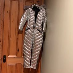 Puffer Insulated Ski Bunny Suit. All In One With Gorgeous Sinch Belt. Detachable Faux Fur Hood. Brand New Without Tags. (I Am 5’9 162# With 38c Bust 31waist 40hips.) It’s To Tight On Me & Sleeves Ran Short On My Wrists. Exact Size Unknown Bc No Tag Luxury Silver Outerwear For Parties, Elegant Fitted Silver Outerwear, Glamorous Fitted Silver Outerwear, Silver Winter Outerwear For Formal Occasions, Silver Formal Outerwear For Winter, Luxury Fitted Silver Outerwear, Silver Evening Outerwear For Winter, Silver Fitted Outerwear For Evening, Ski Bunny