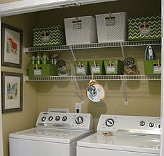 a washer and dryer in a small laundry room with shelves above the washer