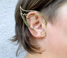 ORDERS PLACED AFTER DECEMBER 1, MAY ARRIVE AFTER CHRISTMAS OR NEW YEAR EVE due to the postal services being overwhelmed this time of year. Average delivery terms USA, France, Ireland - 3-4 weeks Australia, Canada - 4-6 weeks Netherlands, Spain - 2-3 weeks A pair of elf ear cuffs made of brass wire and green glass beads. The elf ears are covered with metal protecting lacquer. No piercing needed. They fit best medium size ears (2 1/3 in - 2 3/4 in ), for larger or smaller ears this pair is made by Handmade Elven Earrings For Gift, Fantasy Metal Ear Cuff For Gift, Green Handmade Ear Cuff For Gift, Elven Style Metal Jewelry Gift, Elven Style Metal Jewelry For Gifts, Handmade Fantasy Metal Cartilage Earrings, Handmade Adjustable Elven Jewelry, Handmade Metal Fantasy Cartilage Earrings, Adjustable Elven Style Metal Jewelry