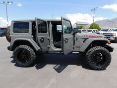 a gray jeep parked in a parking lot