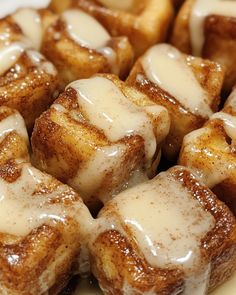 cinnamon rolls with icing on a white plate