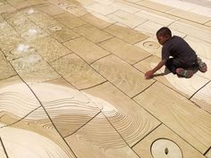 a young boy sitting on the ground next to a skateboard