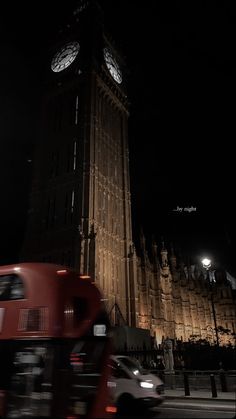 the big ben clock tower towering over the city of london at night with traffic passing by