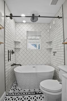 a white bathroom with black and white floor tiles on the walls, an open shower stall and a free standing tub