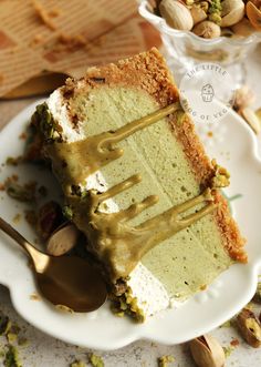 a piece of cake sitting on top of a white plate with a spoon in it