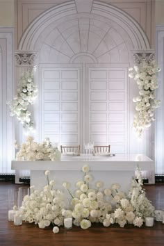 an altar with white flowers and candles