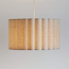 a lamp hanging from a ceiling with three shades of light on it's side