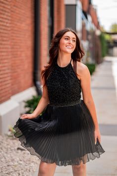 A model in a Sherri Hill cocktail dress features a halter beaded neckline with a pleated tulle skirt. Pleated Tulle Skirt, Pleated Tulle, Hoco Dress, Simple Accessories, Beaded Neckline, Black Halter, Sherri Hill, Hoco Dresses, Glam Fashion