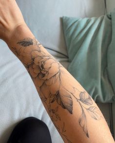 a person with a flower tattoo on their arm